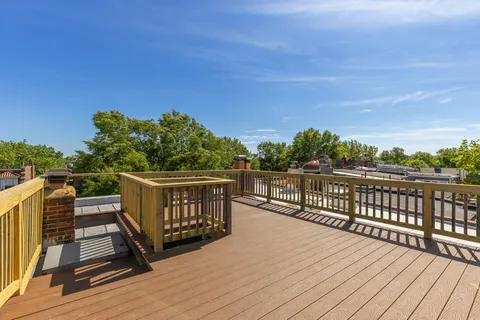 a view of a balcony with wooden floor