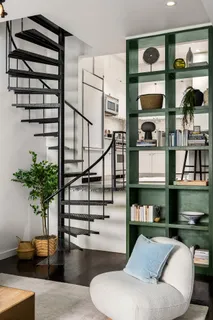 a living room with furniture kitchen view and floor to ceiling window