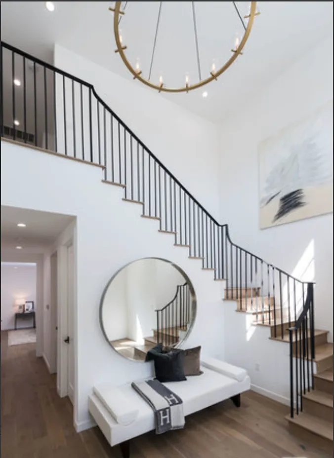 a view of staircase with white walls and a potted plant