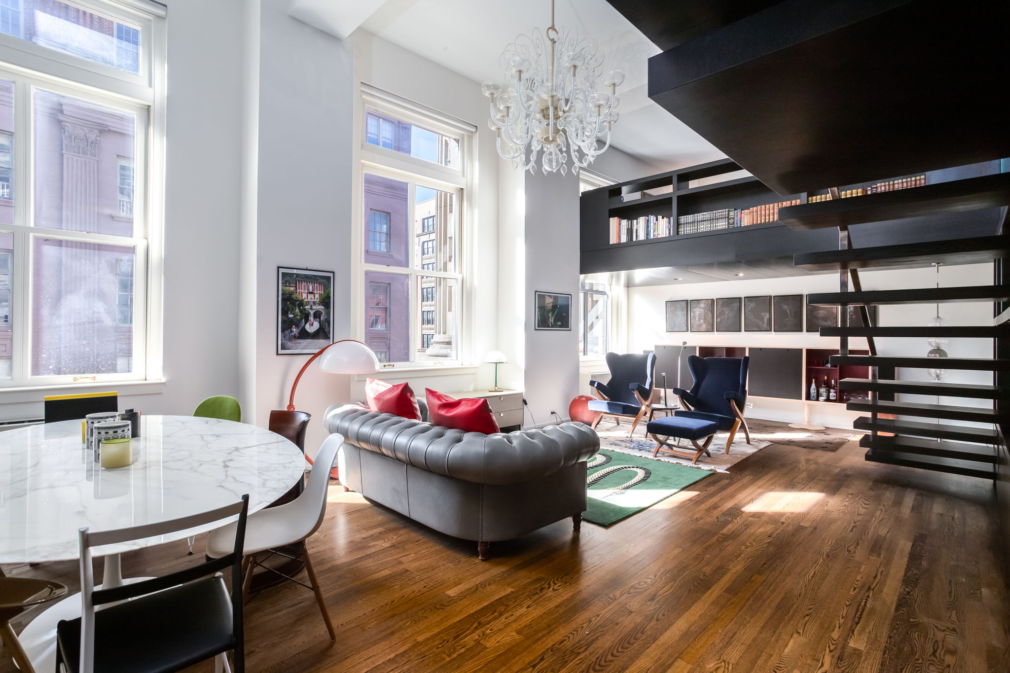 240 Centre Street, Unit 3H Manhattan, NY 10013 - Photo 3 of 20 a living room with furniture a fireplace and a dining table with wooden floor