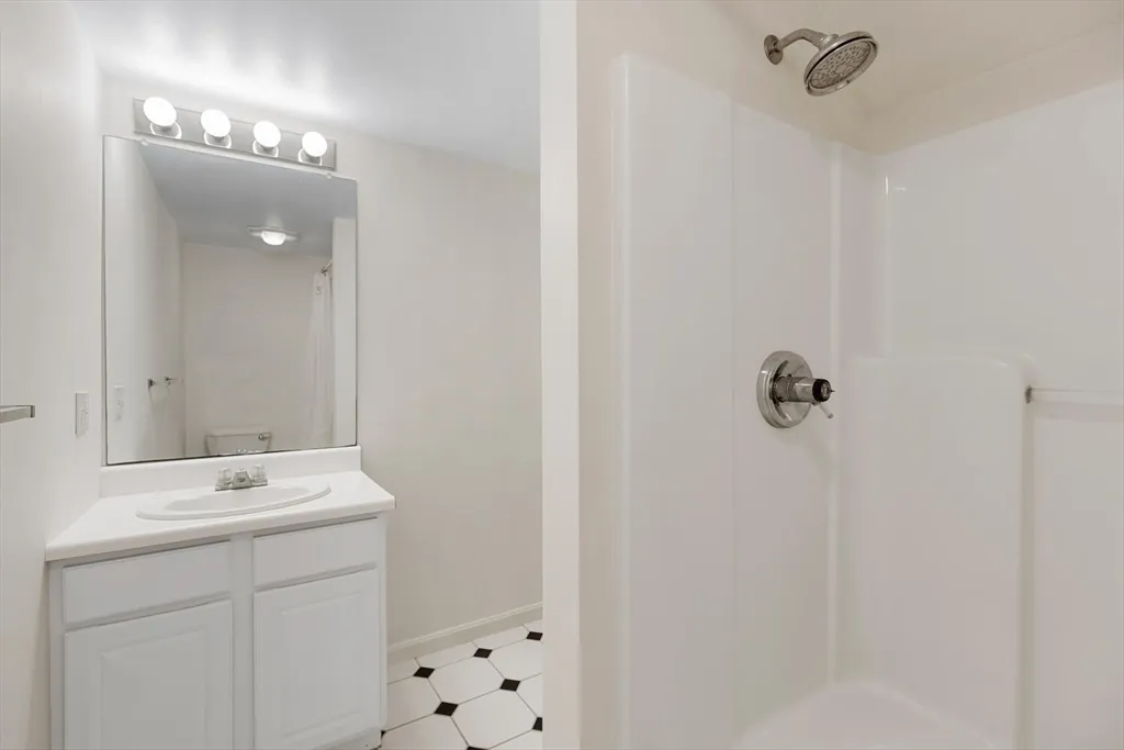 a bathroom with a sink a vanity and a mirror