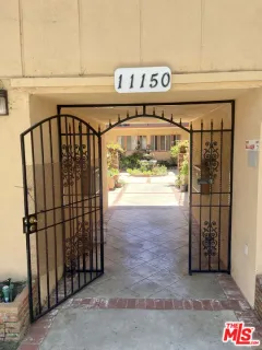 a view of a shop with parking area