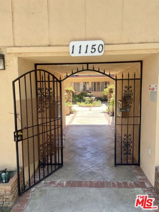 a view of a shop with parking area