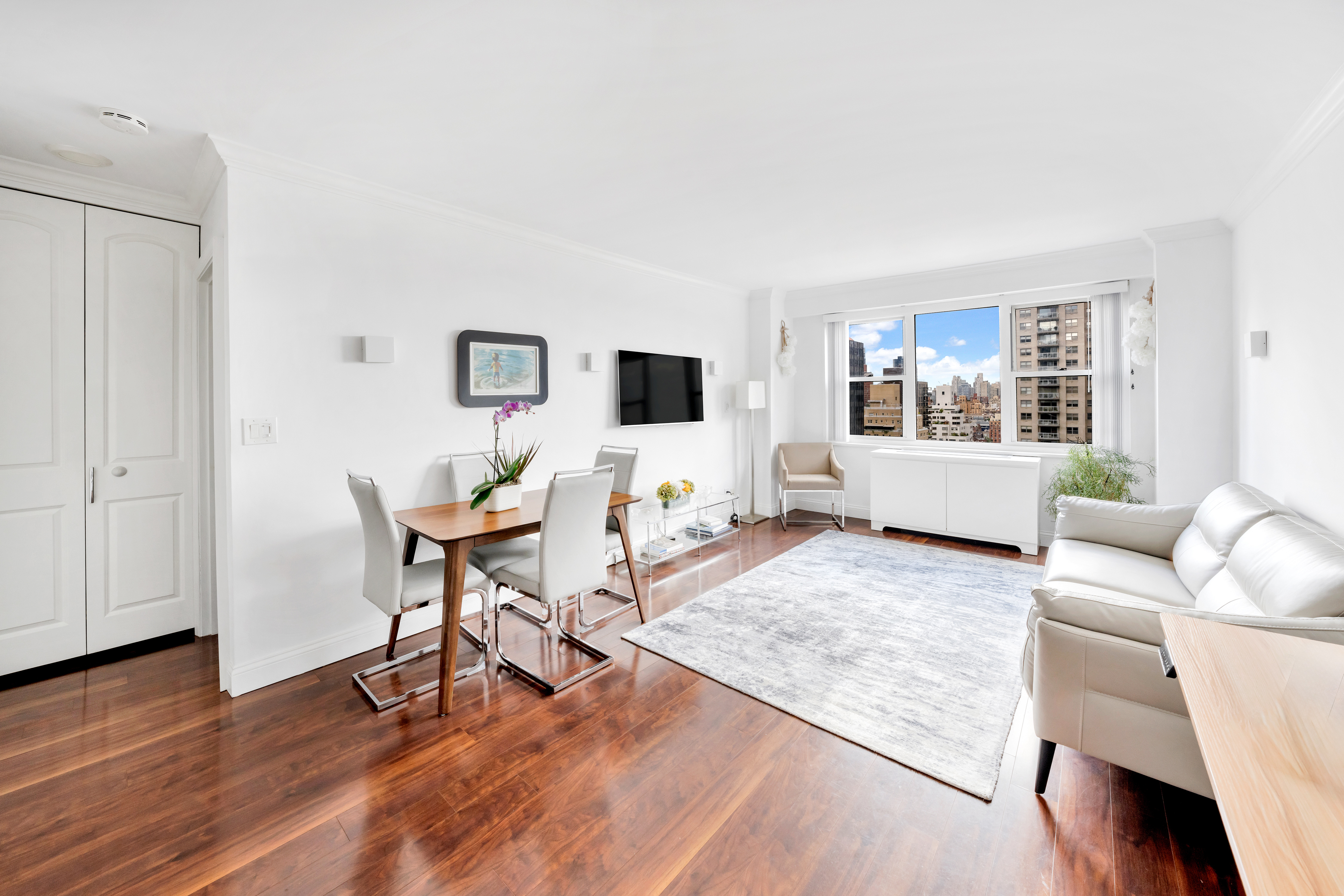 400 East 54th Street, Unit 26D Manhattan, NY 10022 - Photo 1 of 12 a living room with furniture and a wooden floor