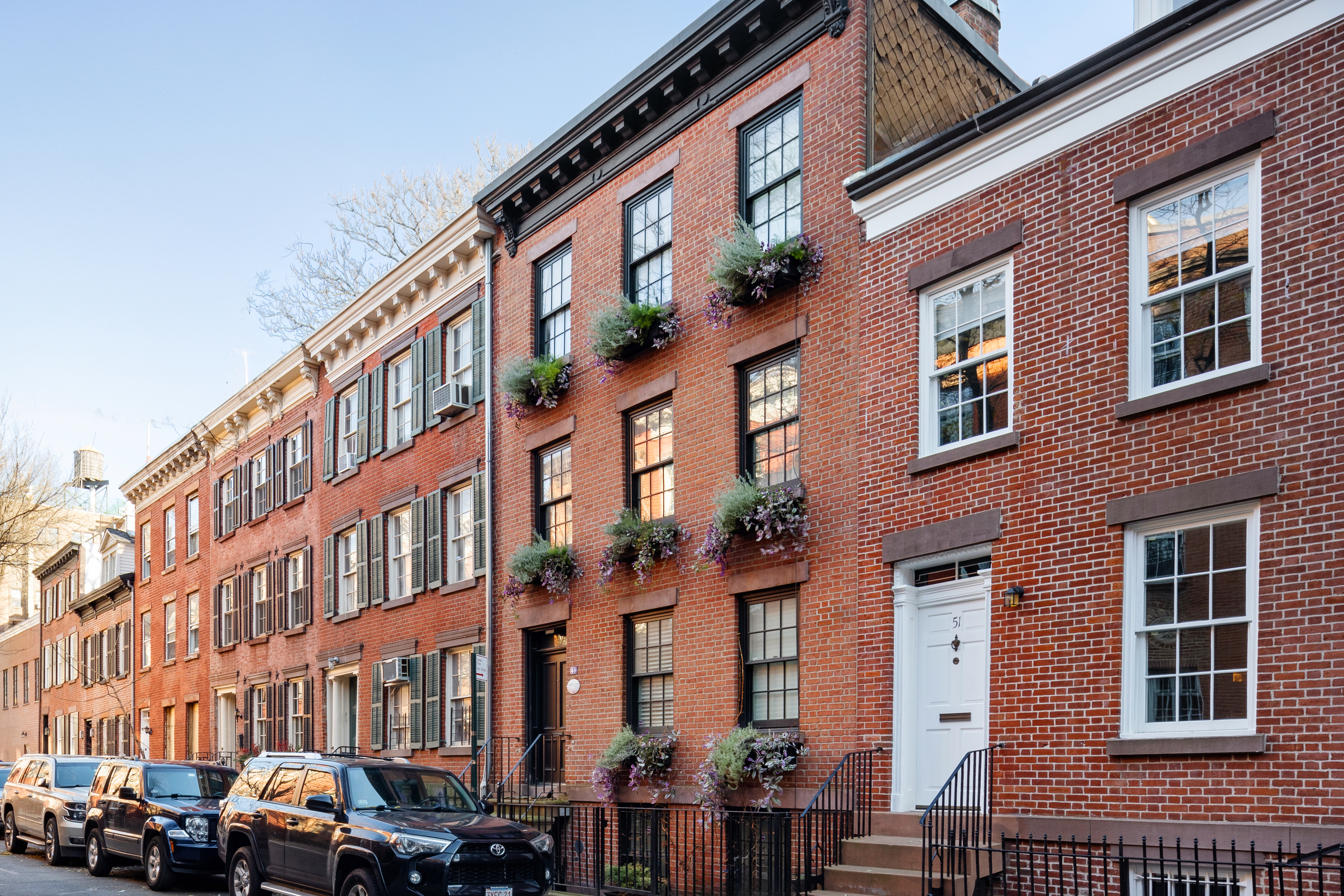 49 Barrow Street Manhattan, NY 10014 - Photo 23 of 25 a front view of a building with lot of cars parked