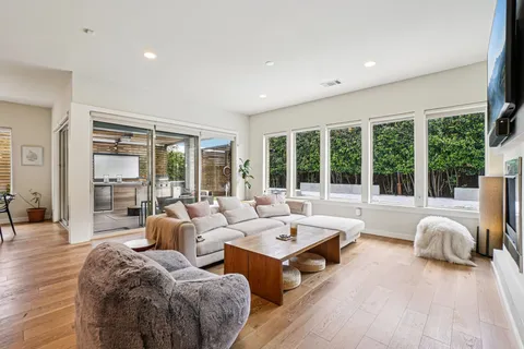 a living room with furniture and large windows