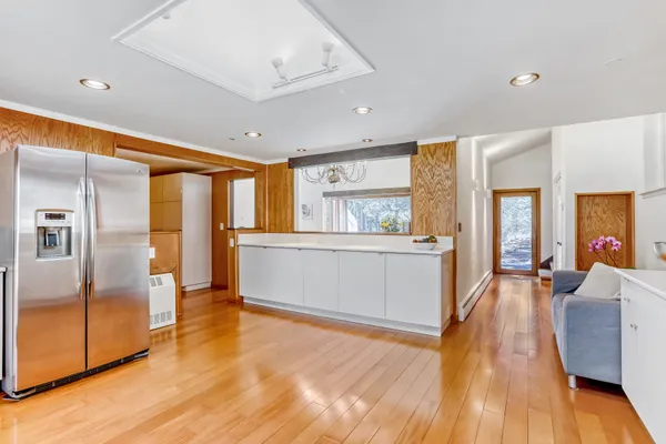 a view of a hallway with entryway wooden floor and front door