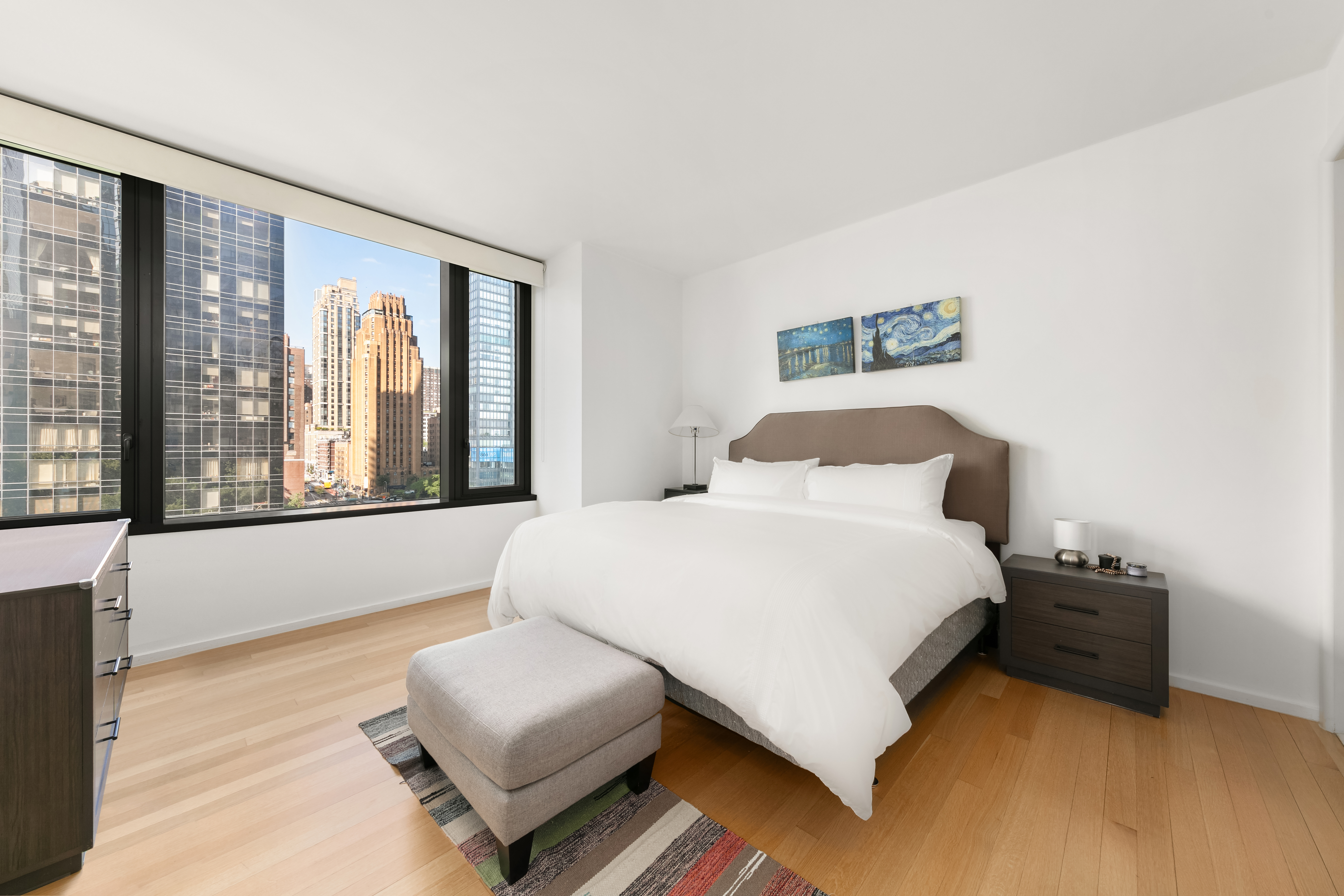 50 United Nations Plaza, Unit 6C Manhattan, NY 10017 - Photo 5 of 15 a bedroom with a bed and a large window