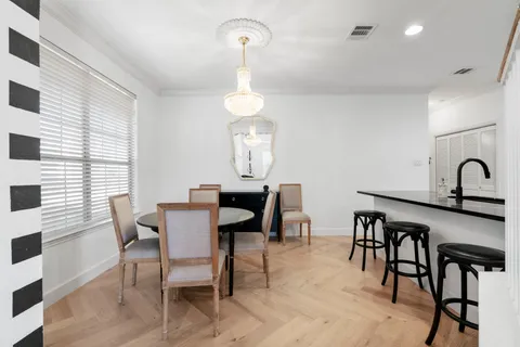 a view of a dining room with furniture and chandelier