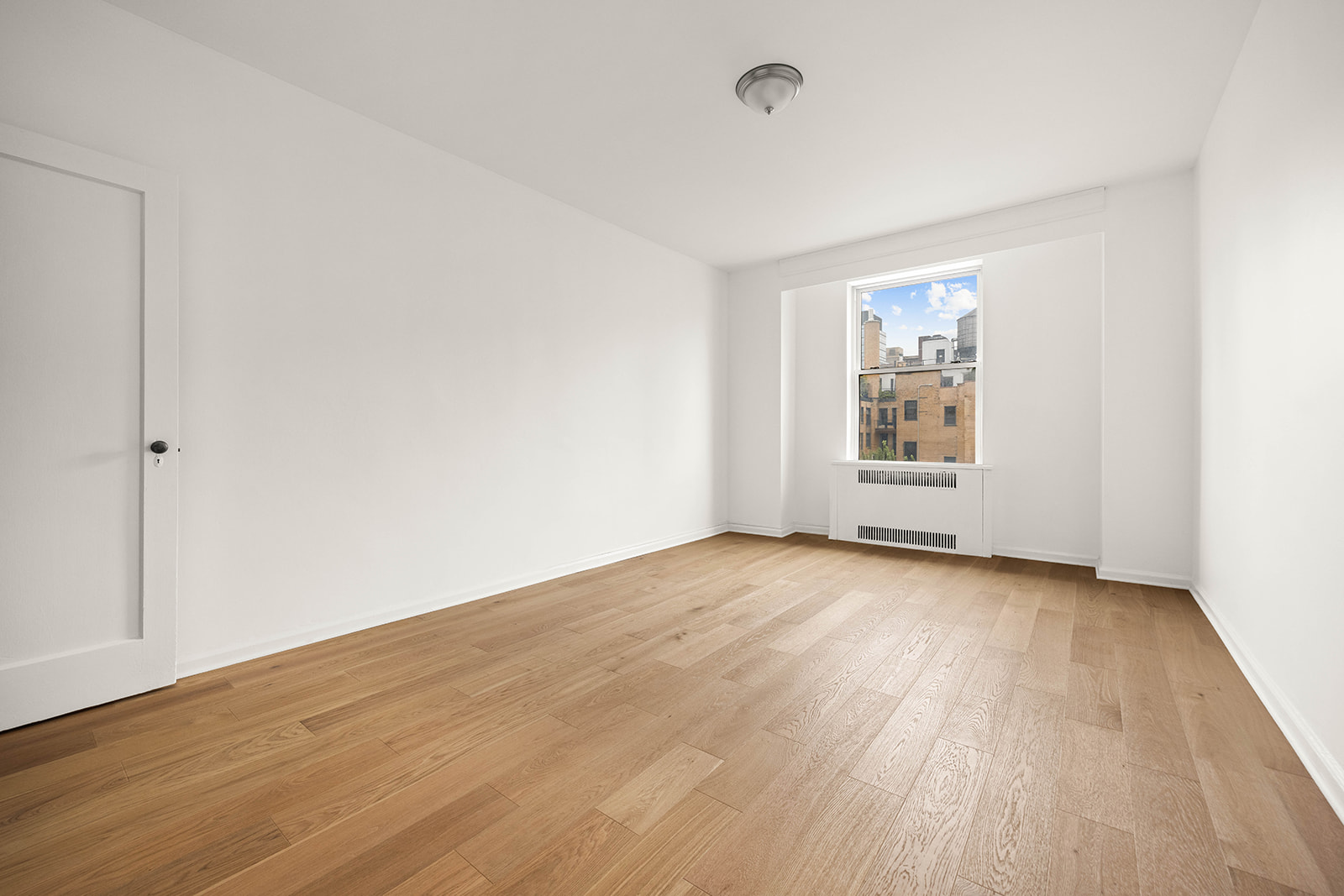 263 West End Avenue, Unit 13F Manhattan, NY 10023 - Photo 12 of 22 an empty room with wooden floor and windows