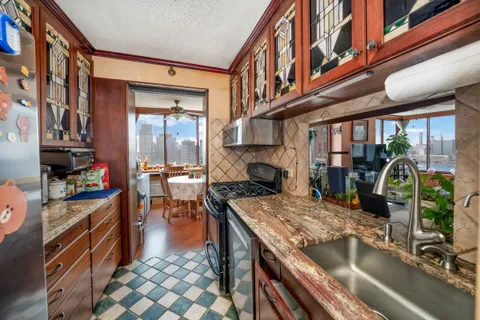 a kitchen with a stove a sink and a refrigerator