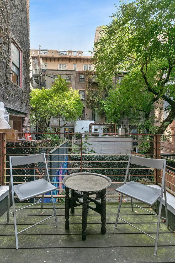 a view of a chairs and table in the patio