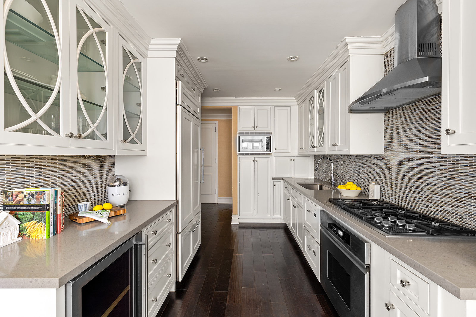 90 East End Avenue, Unit 4B Manhattan, NY 10028 - Photo 3 of 13 a kitchen with stainless steel appliances a stove a sink dishwasher and cabinets