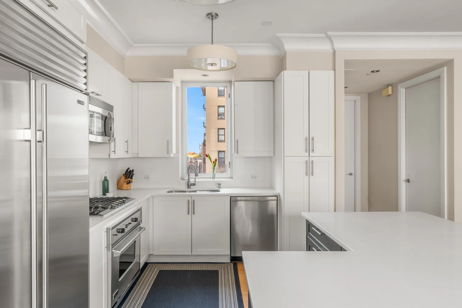 a kitchen with stainless steel appliances a refrigerator sink and cabinets