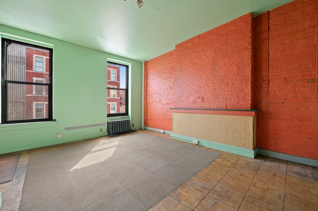 151 1st Avenue, Unit 3F Manhattan, NY 10003 - Photo 2 of 9 an empty room with windows