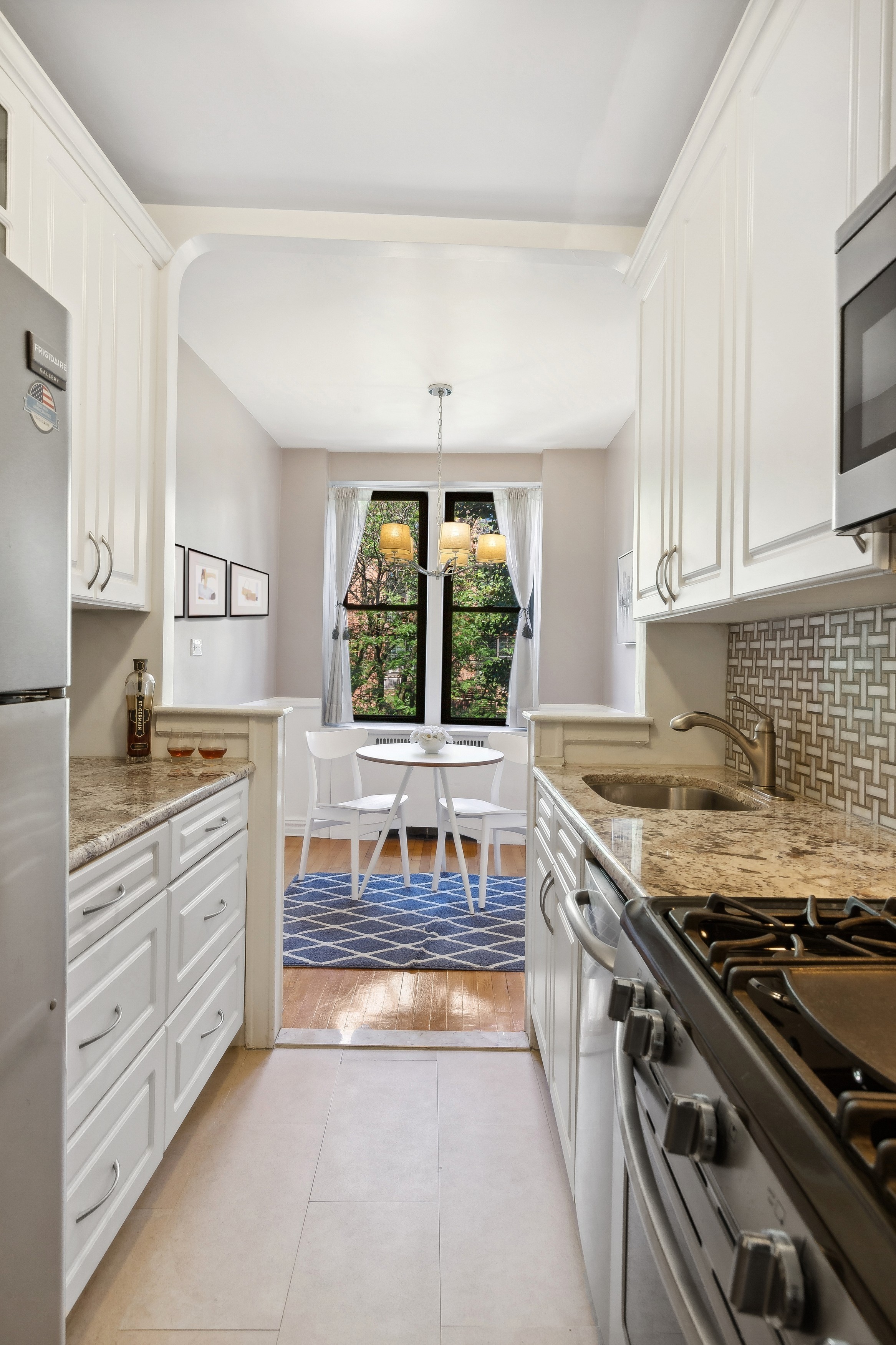 736 West 186th Street, Unit 5B Manhattan, NY 10033 - Photo 3 of 16 a kitchen with stainless steel appliances granite countertop a stove and a sink