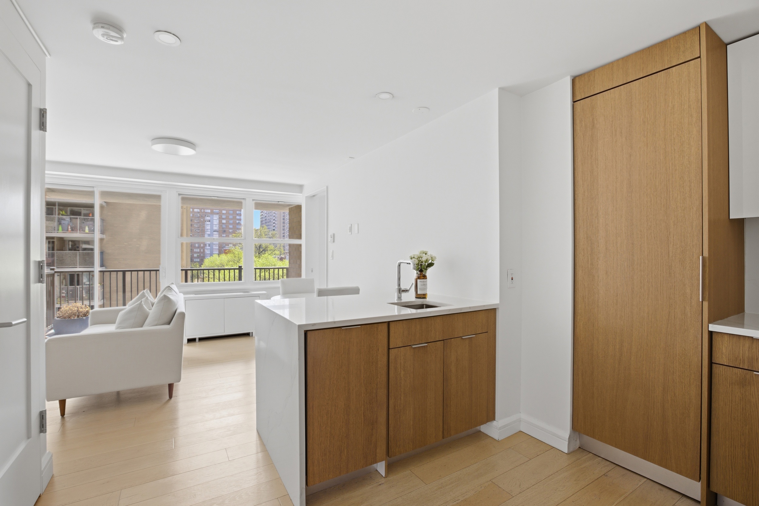 175 West 95th Street, Unit 8H Manhattan, NY 10025 - Photo 2 of 13 a kitchen with kitchen island sink stove and view living room