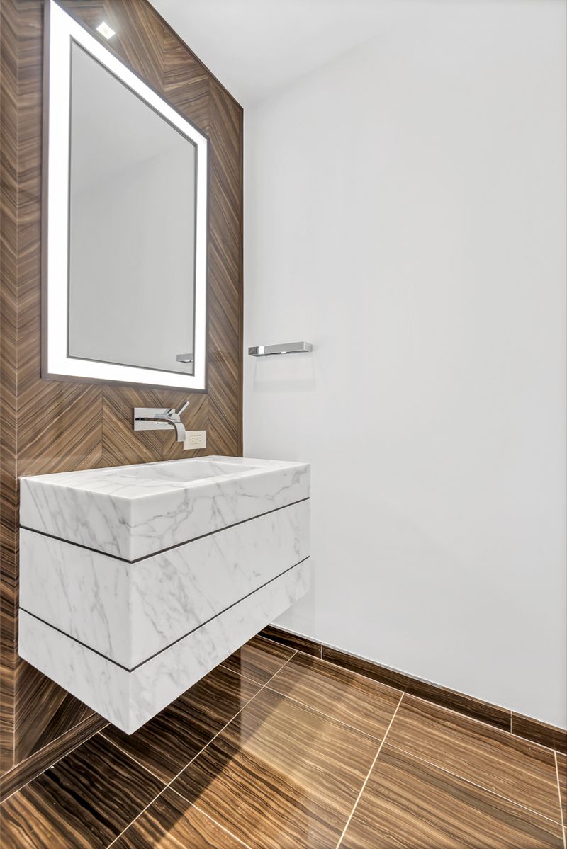 1 West End Avenue, Unit 27D Manhattan, NY 10023 - Photo 8 of 21 a bathroom with a sink and a mirror