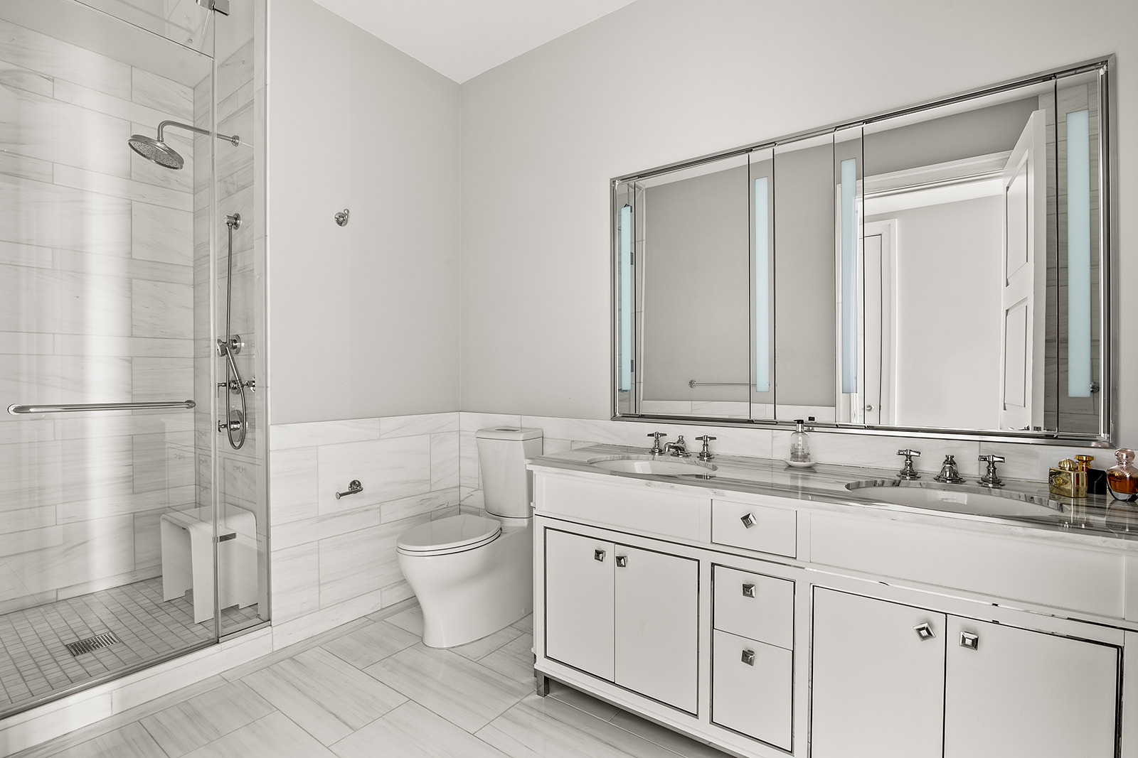 30 Park Place, Unit 43A Manhattan, NY 10007 - Photo 7 of 13 a bathroom with a granite countertop sink a mirror and a shower
