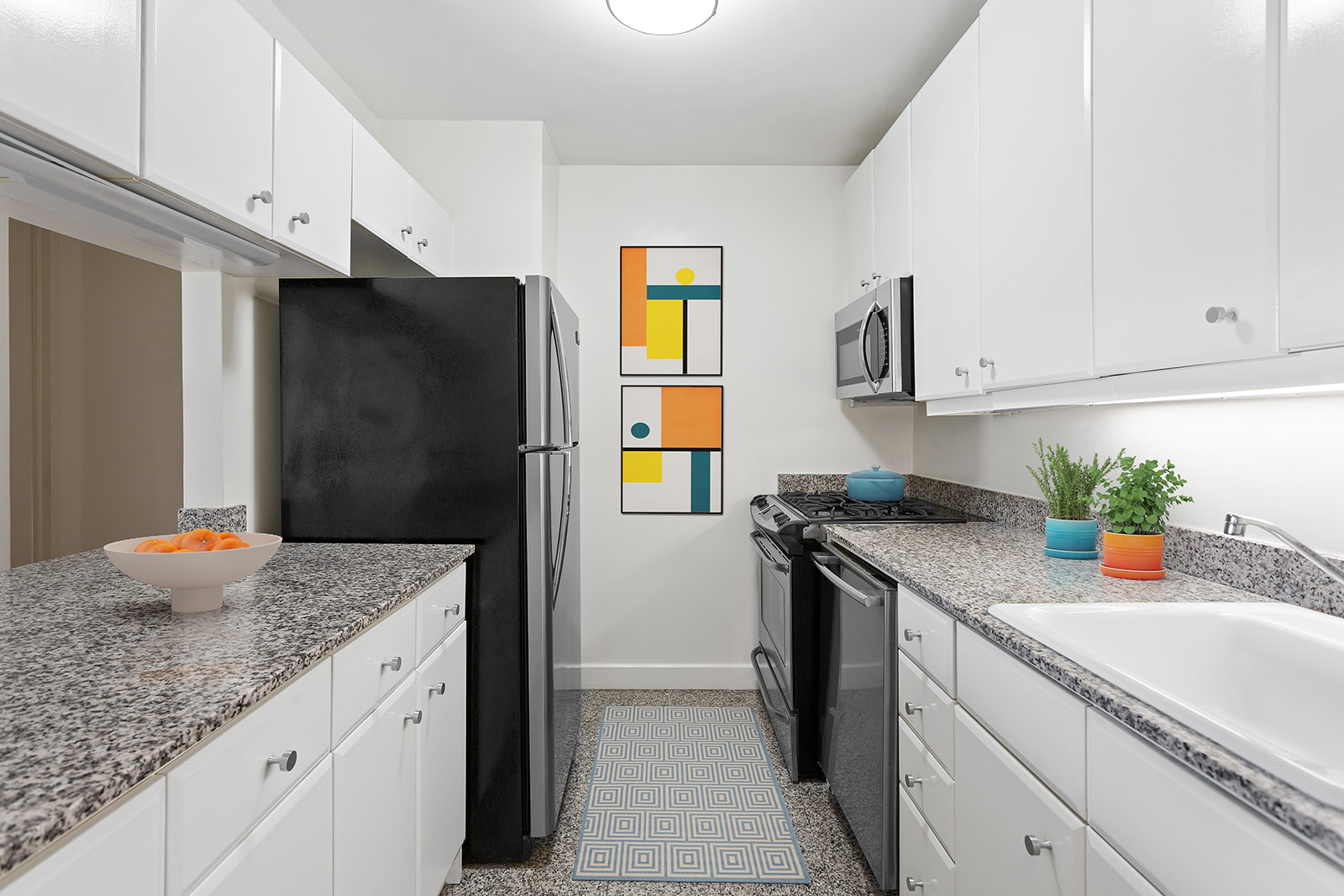 1965 Broadway, Unit 11D Manhattan, NY 10023 - Photo 8 of 13 a kitchen with stainless steel appliances granite countertop a refrigerator and a sink