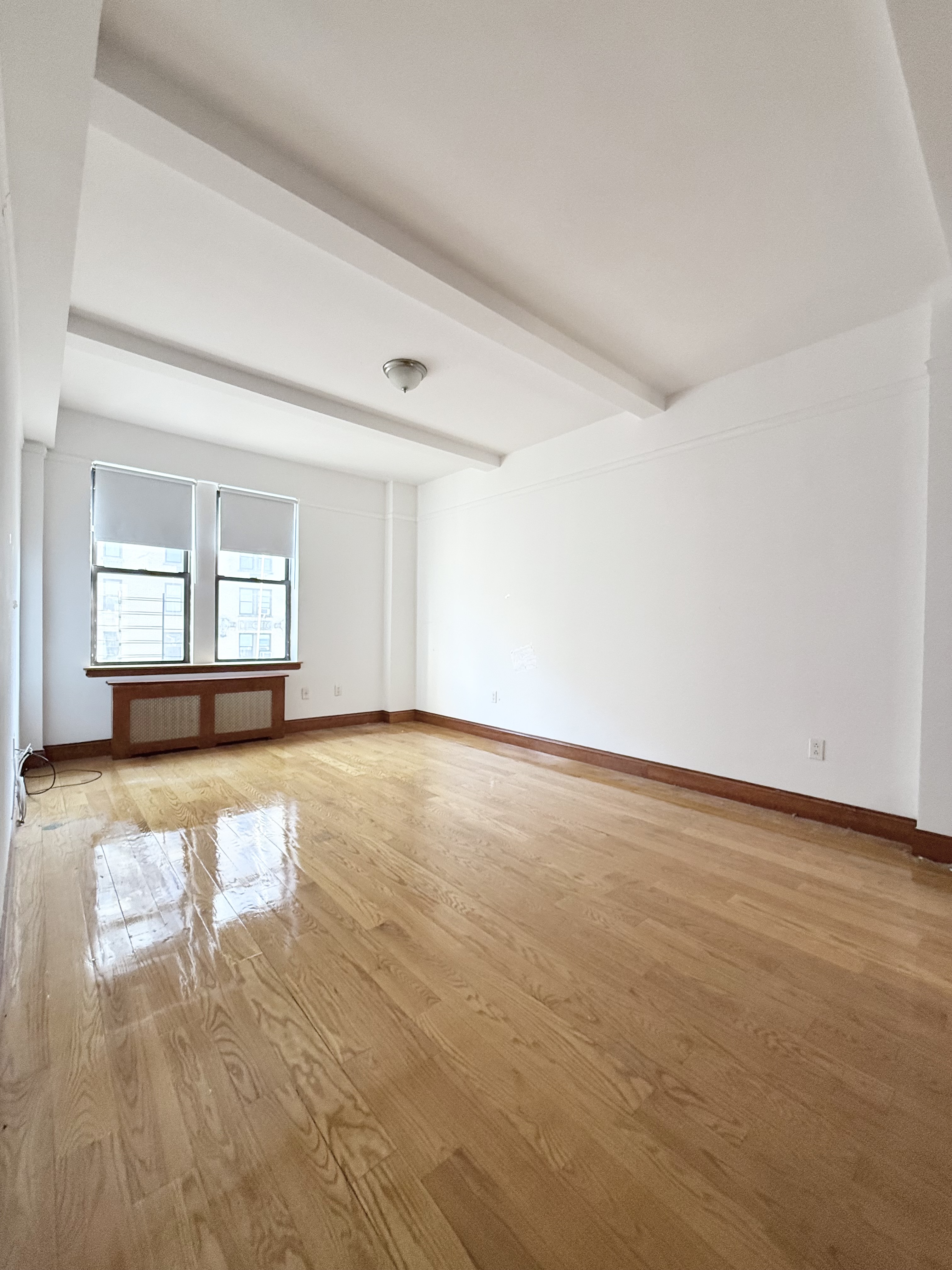675 West End Avenue, Unit 12A Manhattan, NY 10025 - Photo 8 of 15 a view of empty room with wooden floor and fan