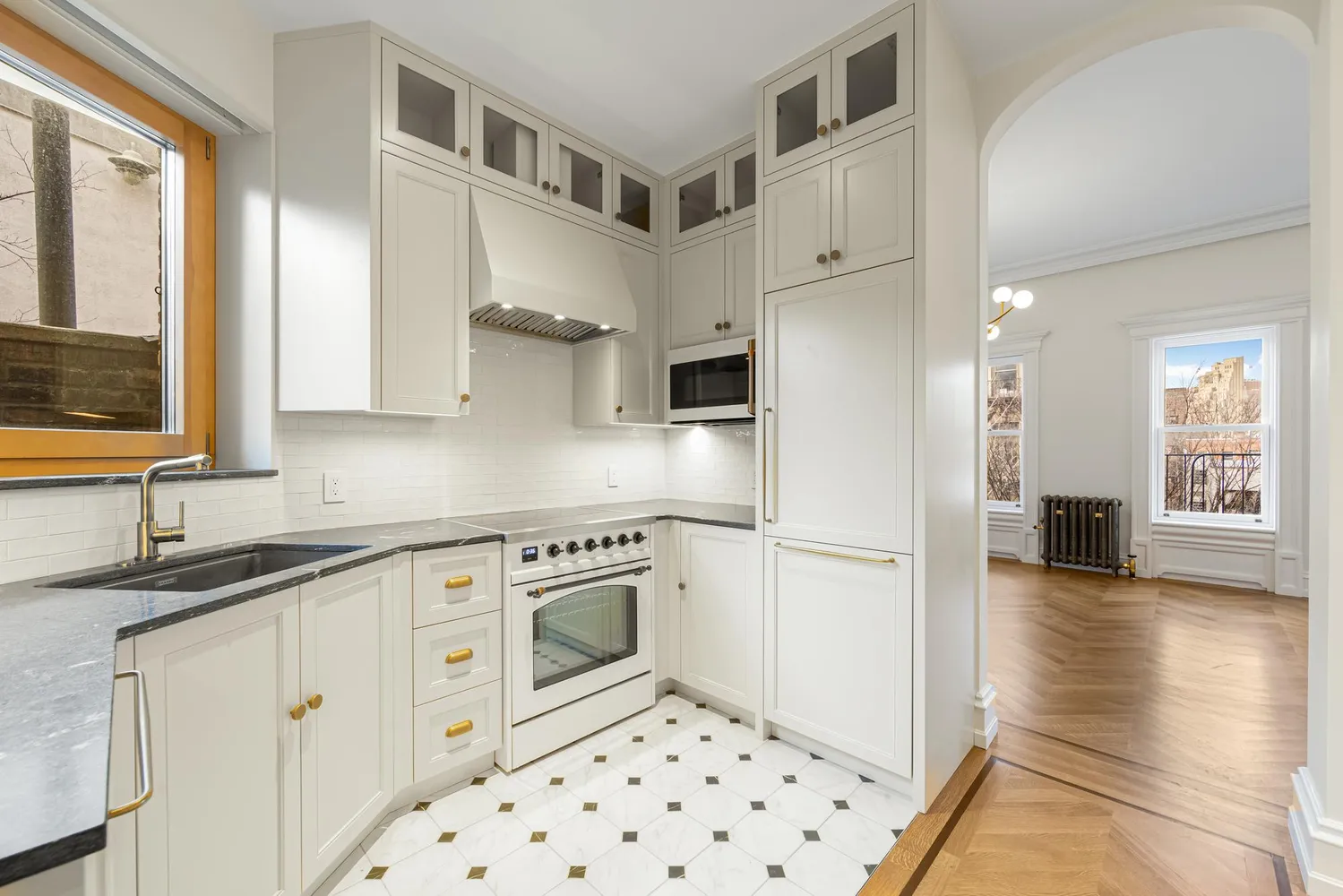 a kitchen with stainless steel appliances a refrigerator sink and cabinets
