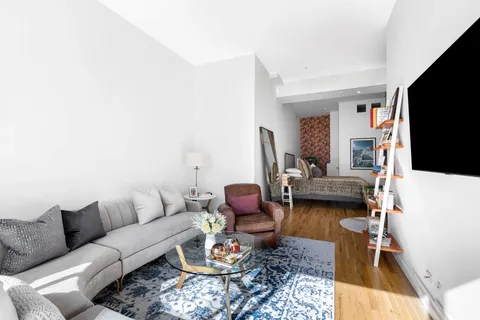 a living room with furniture fireplace and a flat screen tv