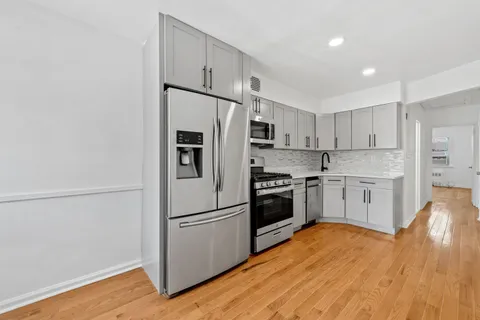 a kitchen with stainless steel appliances a refrigerator sink and cabinets