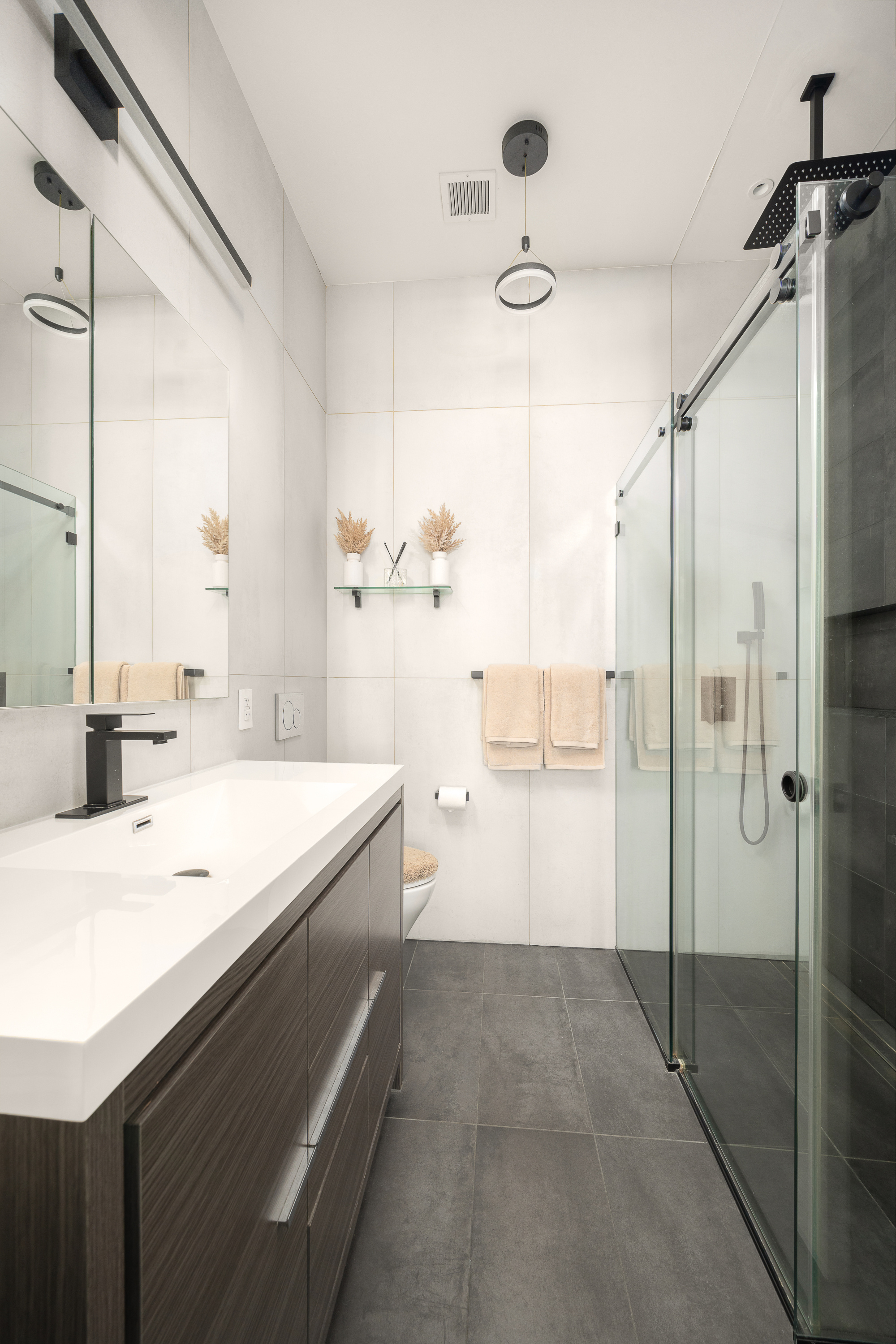 521 West 47th Street, Unit 3B Manhattan, NY 10036 - Photo 13 of 15 a bathroom with a sink a toilet and shower