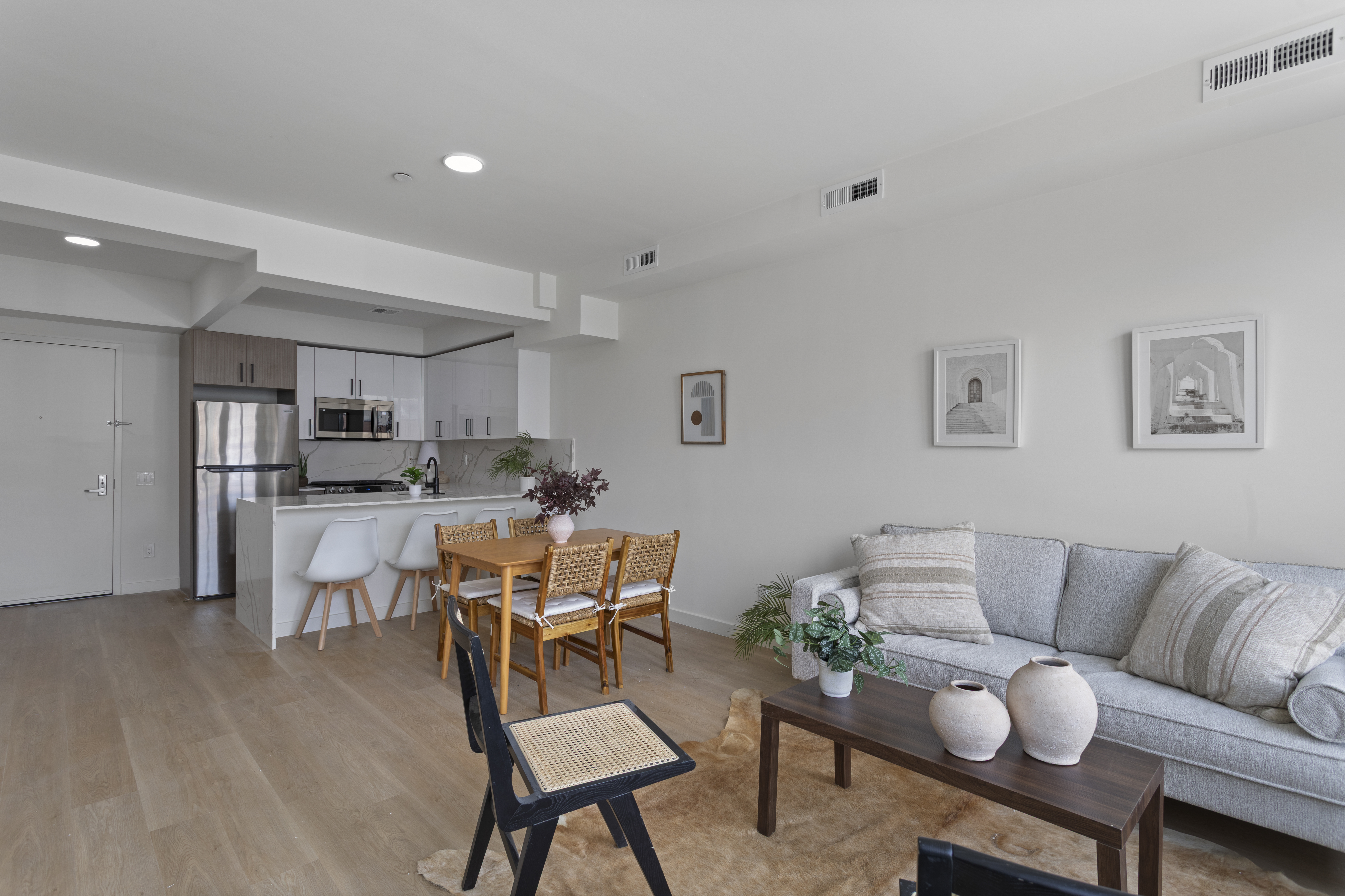 a living room with furniture and kitchen view