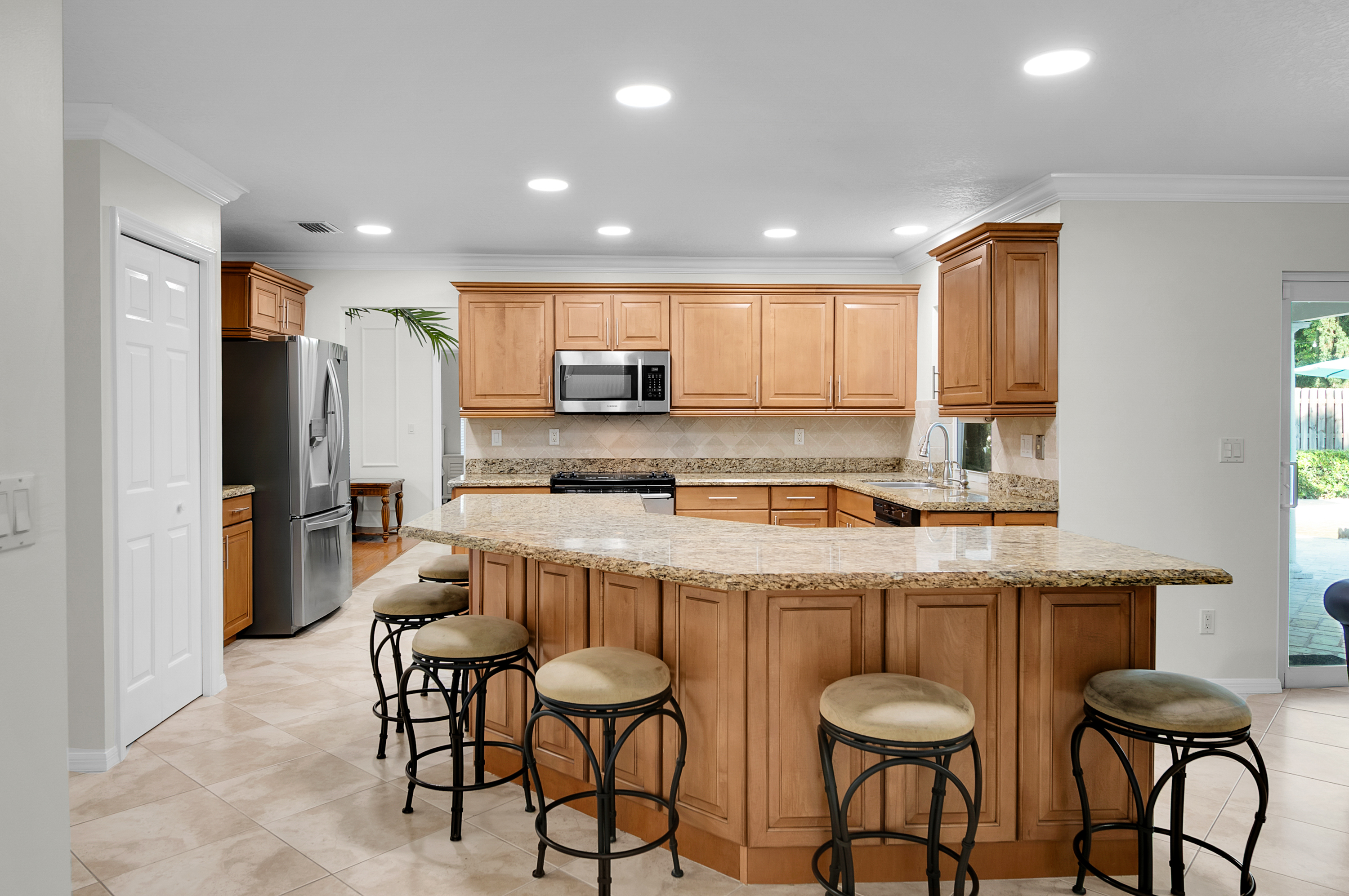 1560 Southwest 16th Street Boca Raton, FL 33486 - Photo 31 of 72 a kitchen with stainless steel appliances granite countertop a sink and a refrigerator