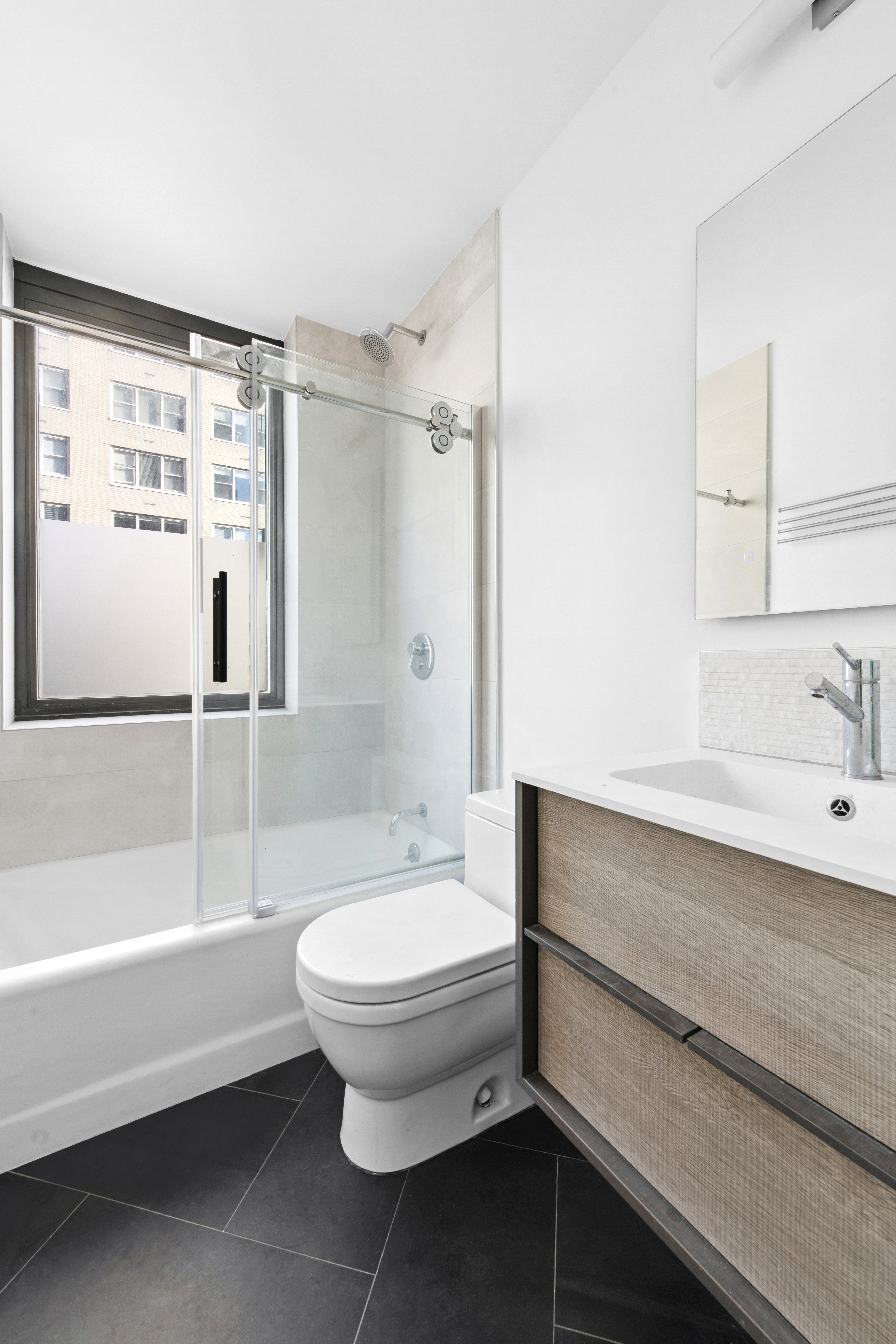 330 East 75th Street, Unit 5B Manhattan, NY 10021 - Photo 10 of 11 a bathroom with a sink toilet and shower
