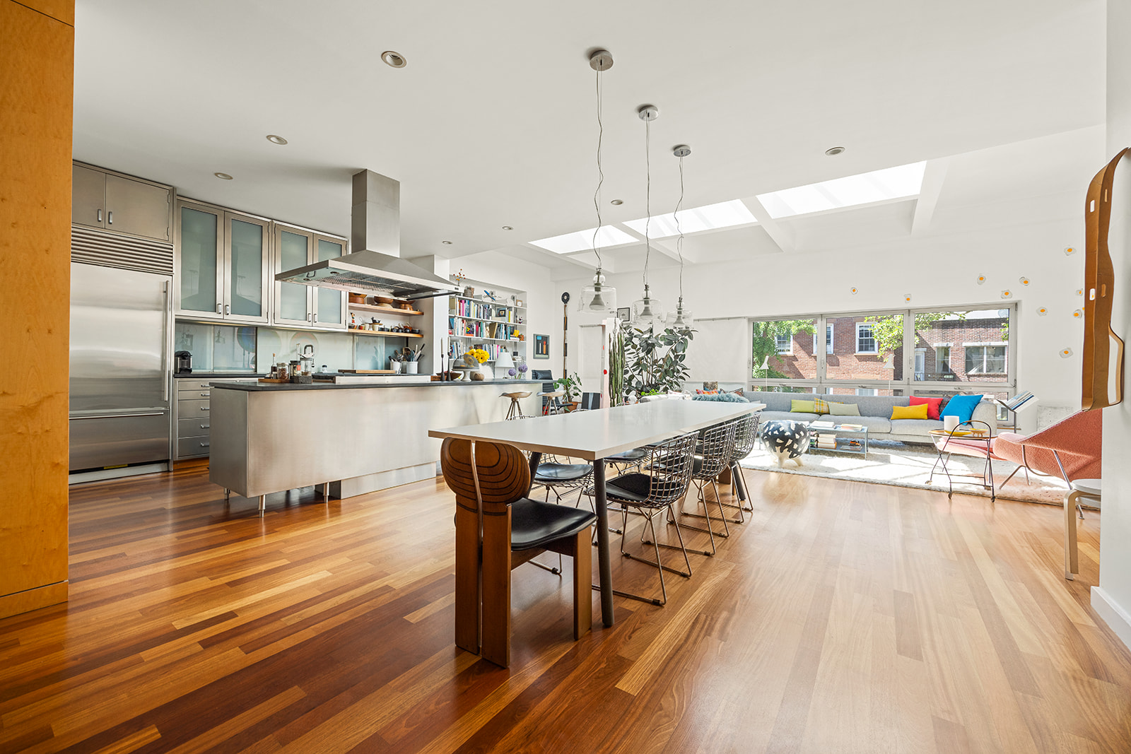 113 2nd Street, Unit 2 Brooklyn, NY 11231 - Photo 3 of 19 a dining room with stainless steel appliances kitchen island granite countertop a table chairs and a living room view