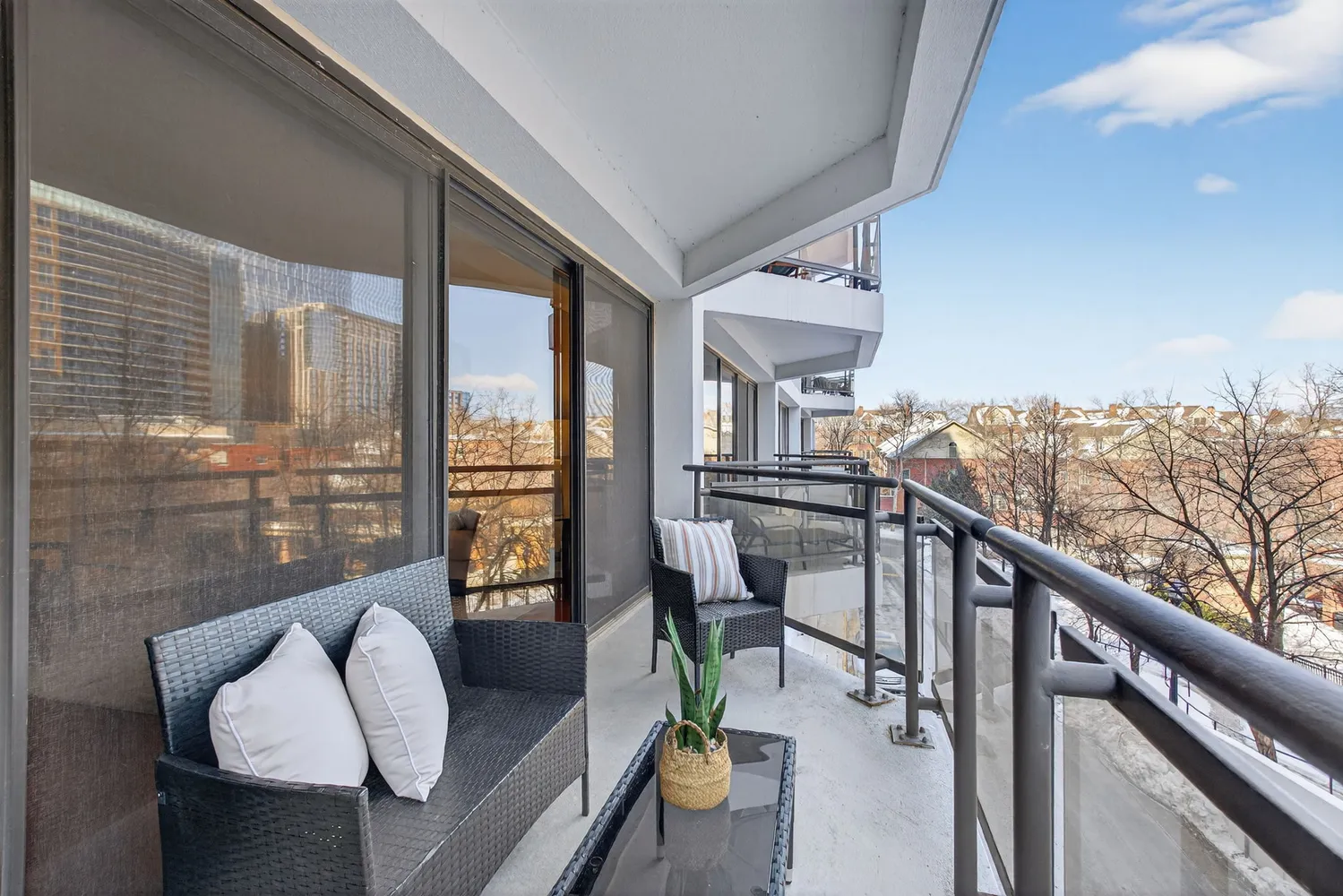 a balcony view with furniture and a floor to ceiling window