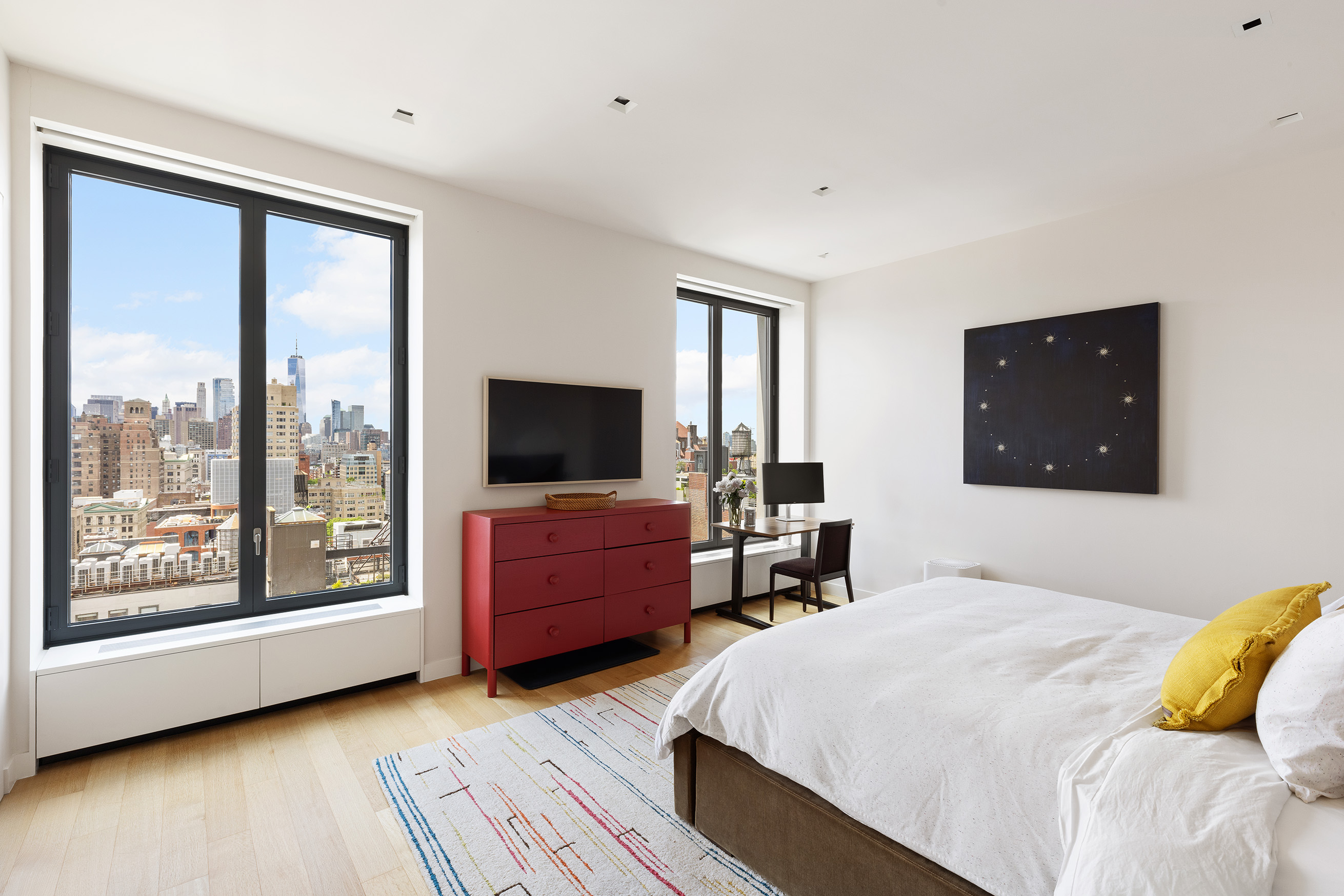 21 East 12th Street, Unit 17B Manhattan, NY 10003 - Photo 8 of 13 a bedroom with a large bed and a flat tv screen on dresser