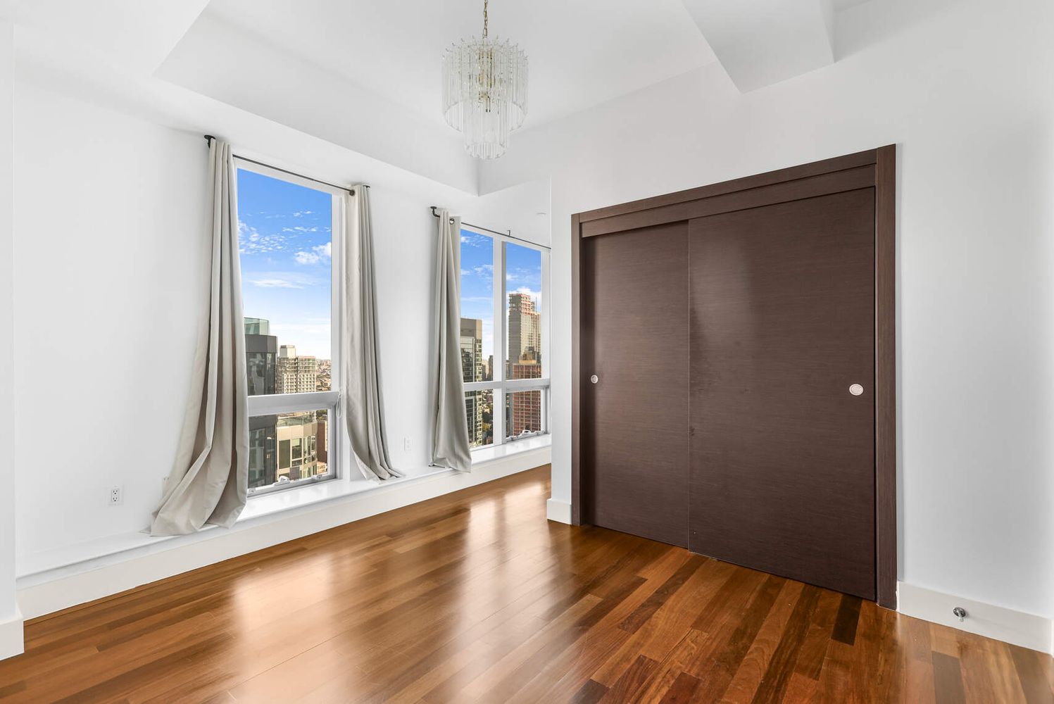 150 Myrtle Avenue, Unit PH3201 Brooklyn, NY 11201 - Photo 19 of 40 a view of an empty room with wooden floor and a window