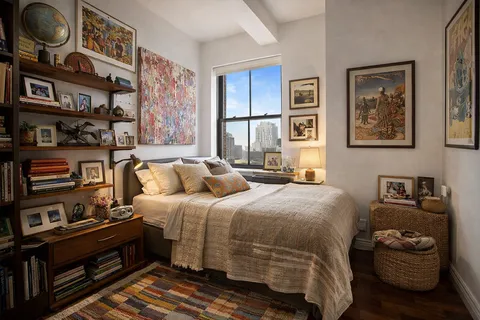 a bedroom with a bed and cabinets
