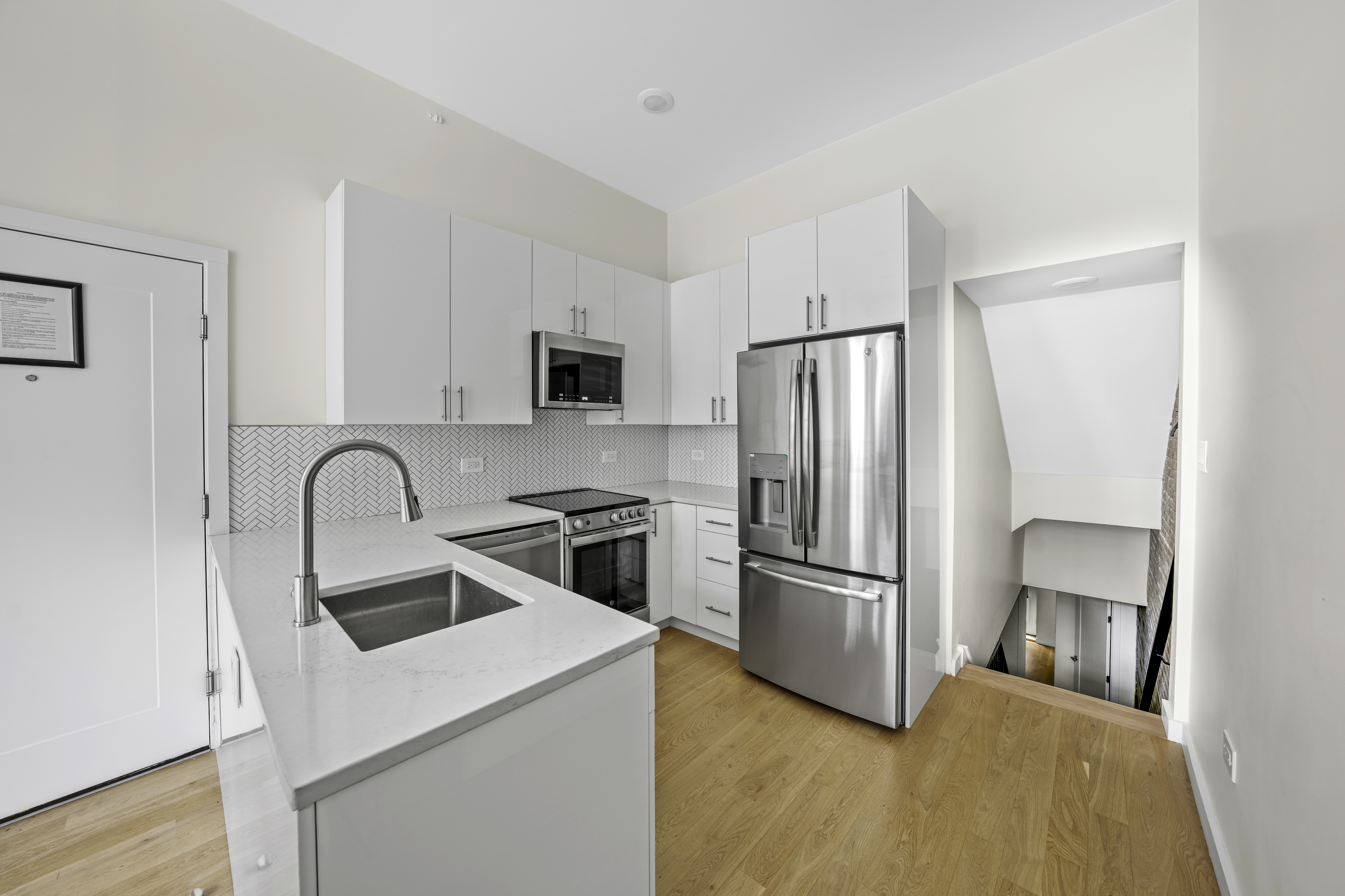 950 St Nicholas Avenue, Unit 1 Manhattan, NY 10032 - Photo 3 of 16 a kitchen with a refrigerator sink and stainless steel appliances