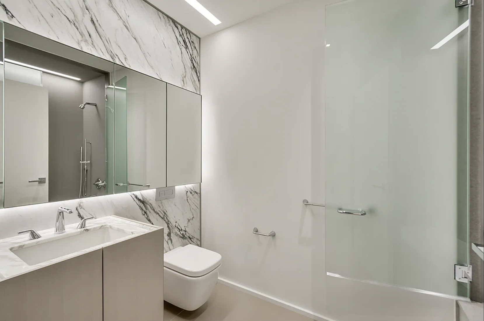 121 East 22nd Street, Unit N203 Manhattan, NY 10010 - Photo 4 of 10 a bathroom with a sink toilet and shower