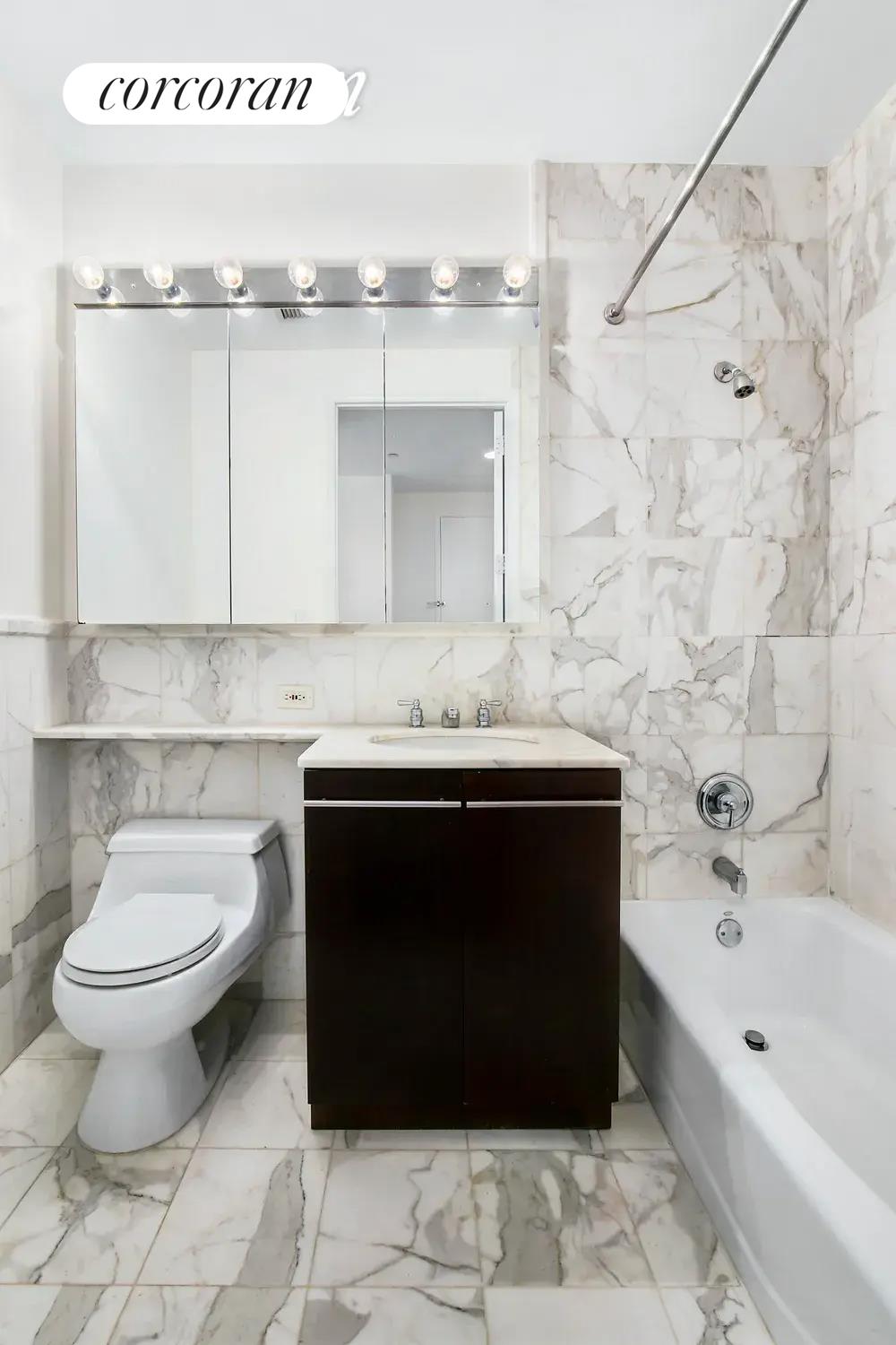 150 Nassau Street, Unit 8K Manhattan, NY 10038 - Photo 4 of 8 a bathroom with a sink a toilet and bathtub