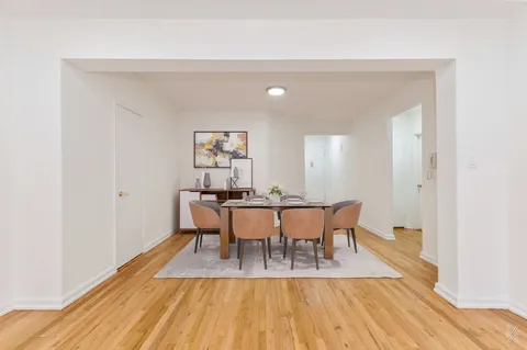 a view of a dining room with furniture and wooden floor