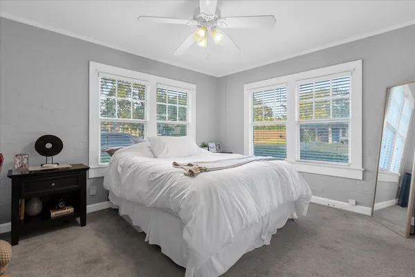 a spacious bedroom with a bed and a window