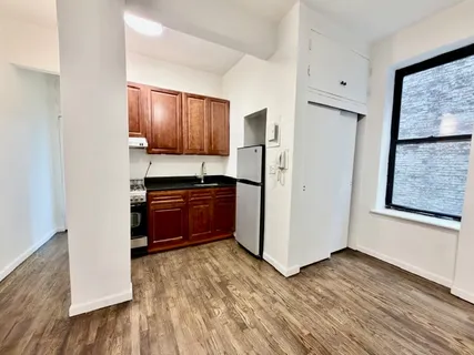 a kitchen with granite countertop wooden cabinets and a stainless steel appliances