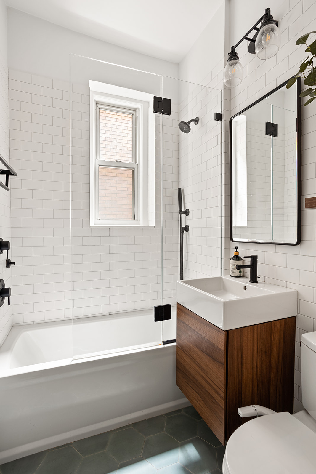 129 Columbia Heights, Unit 3 Brooklyn, NY 11201 - Photo 5 of 7 a bathroom with a bathtub sink and mirror
