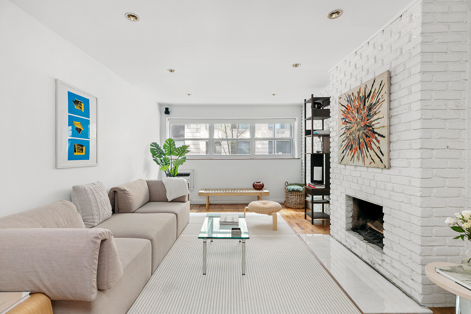 49 East 12th Street, Unit 2C Manhattan, NY 10003 - Photo 1 of 9 a living room with furniture a fireplace and a potted plant