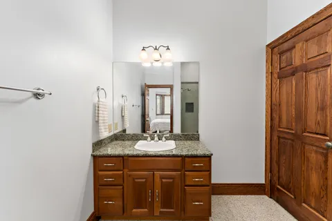 a living room with stainless steel appliances kitchen island granite countertop furniture and a ceiling fan
