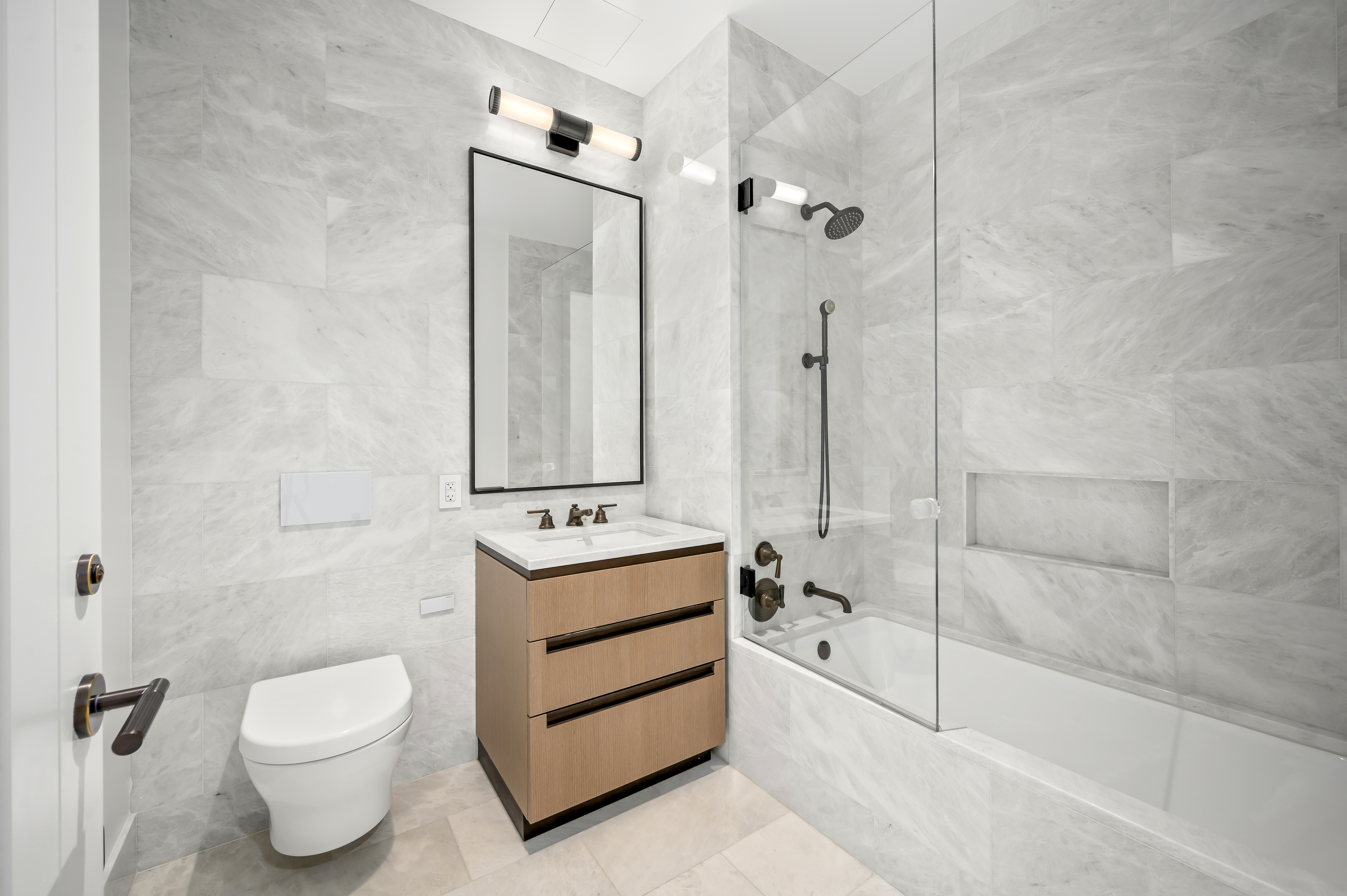 515 West 18th Street, Unit 1401 Manhattan, NY 10011 - Photo 6 of 12 a bathroom with a toilet a sink and shower