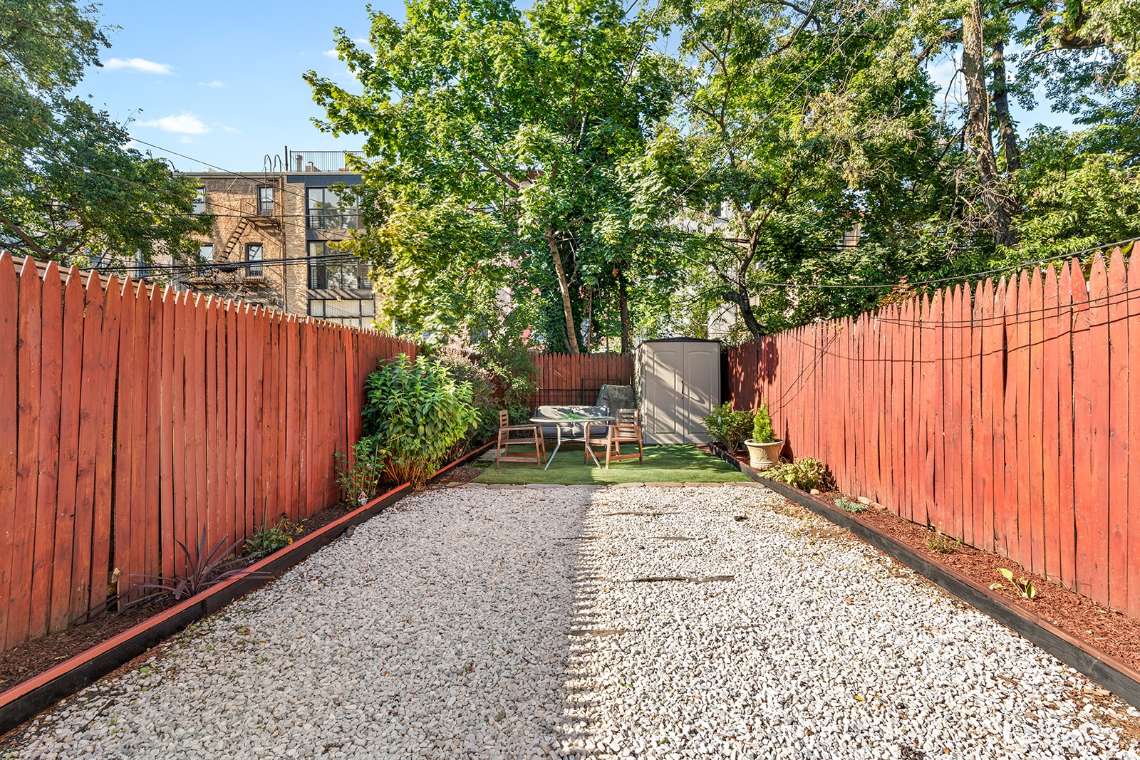 383 Bainbridge Street, Unit 1 Brooklyn, NY 11233 - Photo 5 of 14 a view of a backyard with wooden fence and plants