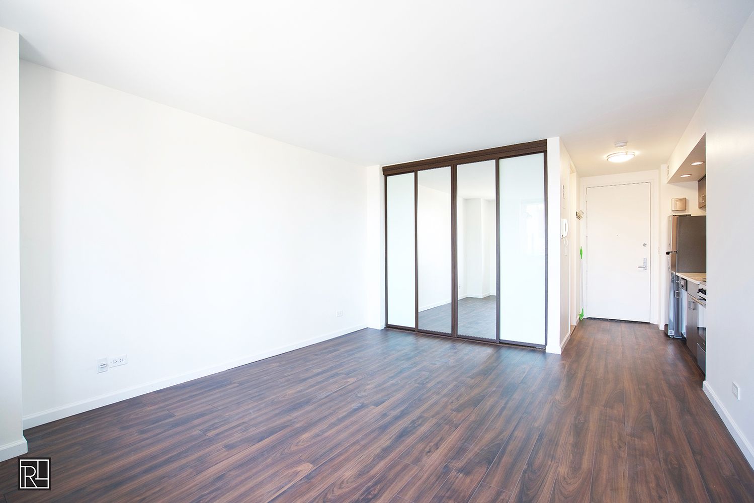 300 East 62nd Street, Unit 1405 Manhattan, NY 10065 - Photo 6 of 10 a view of an empty room with wooden floor and a window