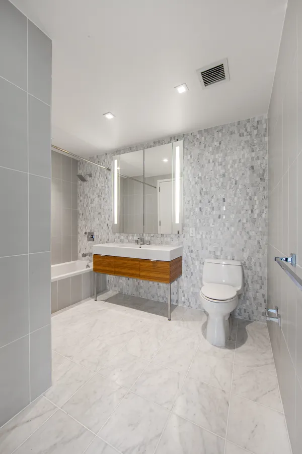 a spacious bathroom with a bathtub and toilet